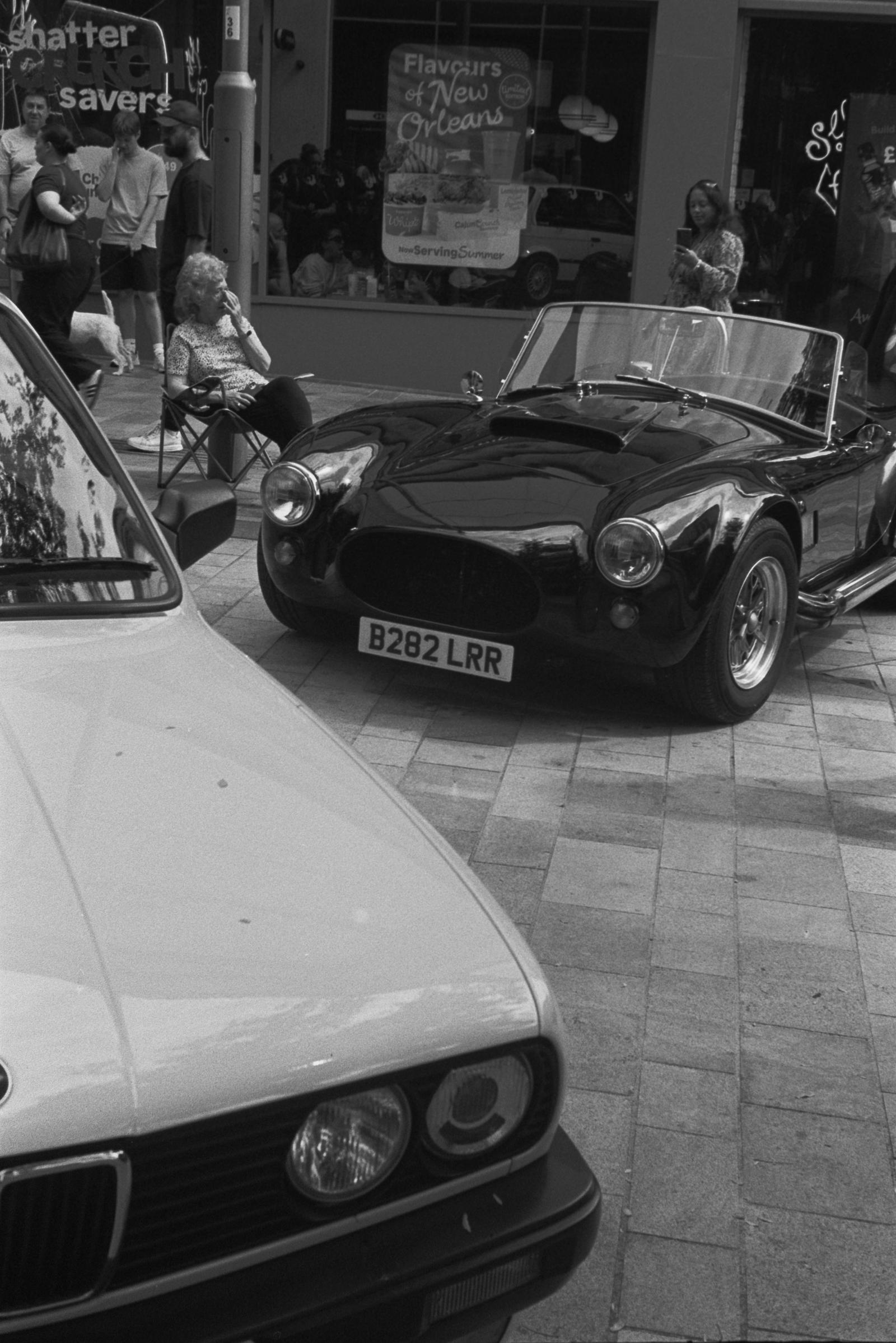 Two cars and some people